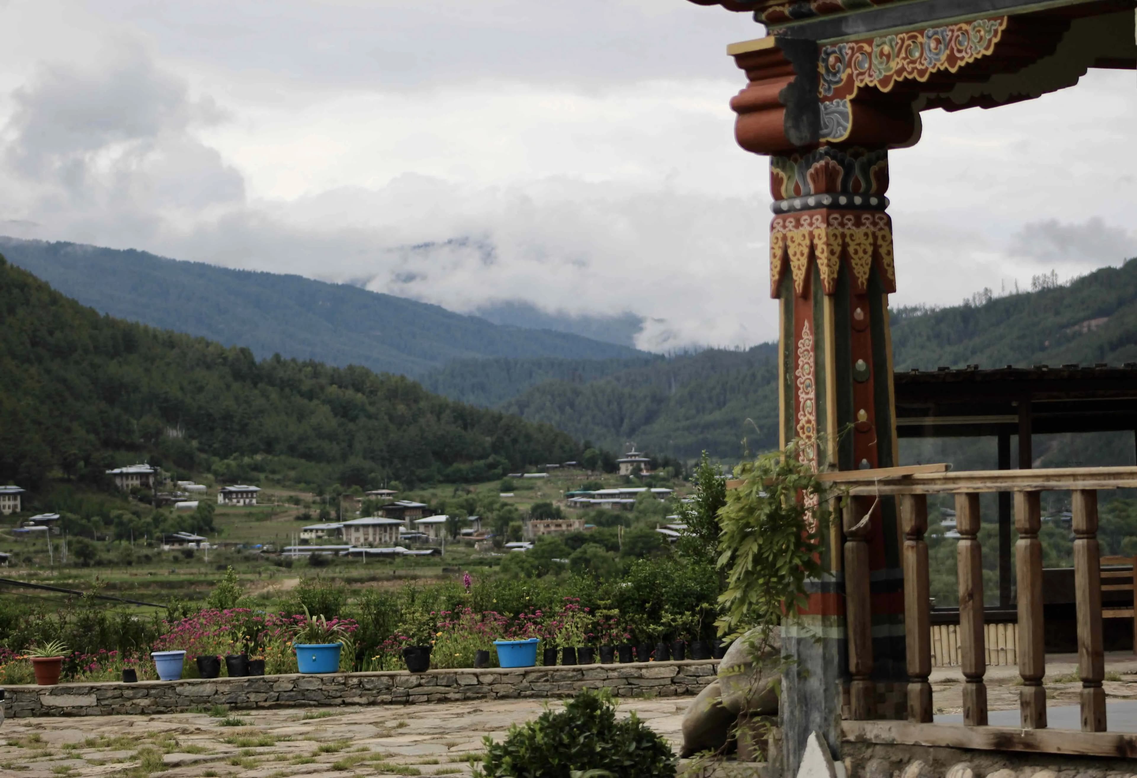A tea cup set in the foreground, with Chamkhar Valley in the background