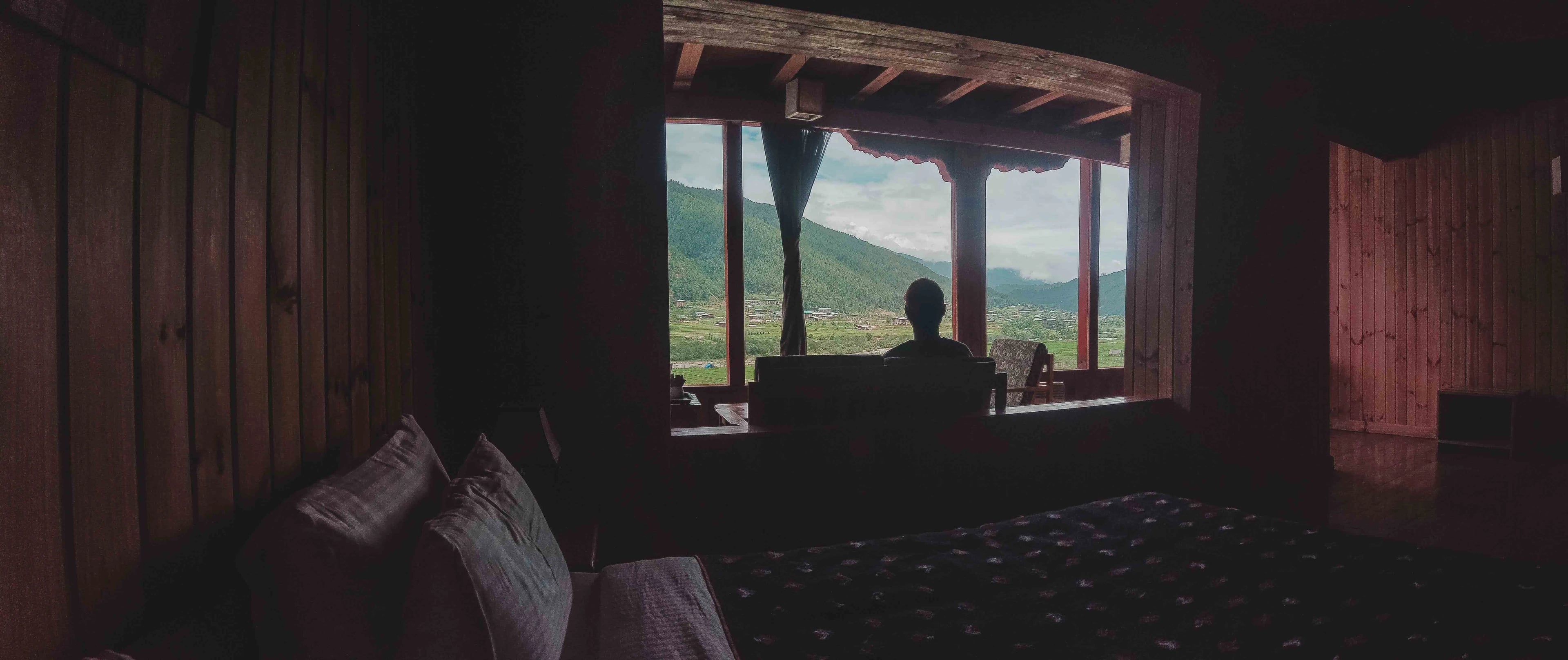 A shot of the view from the bed of room 202, featuring the chamkhar valley in the background