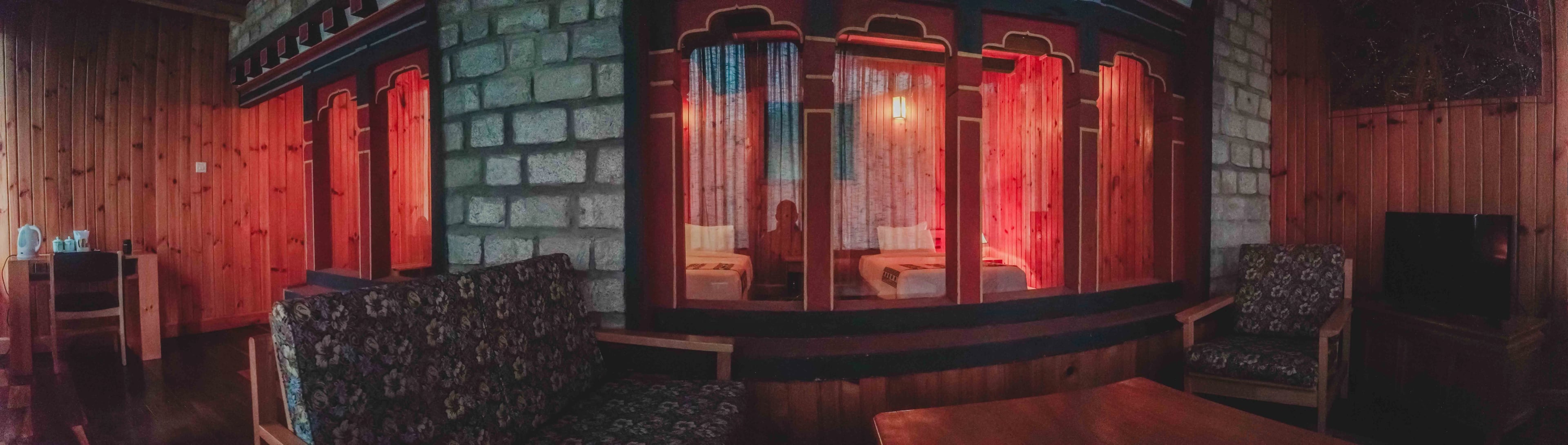A shot of the divider between the room and lounge area featuring drukpa windows