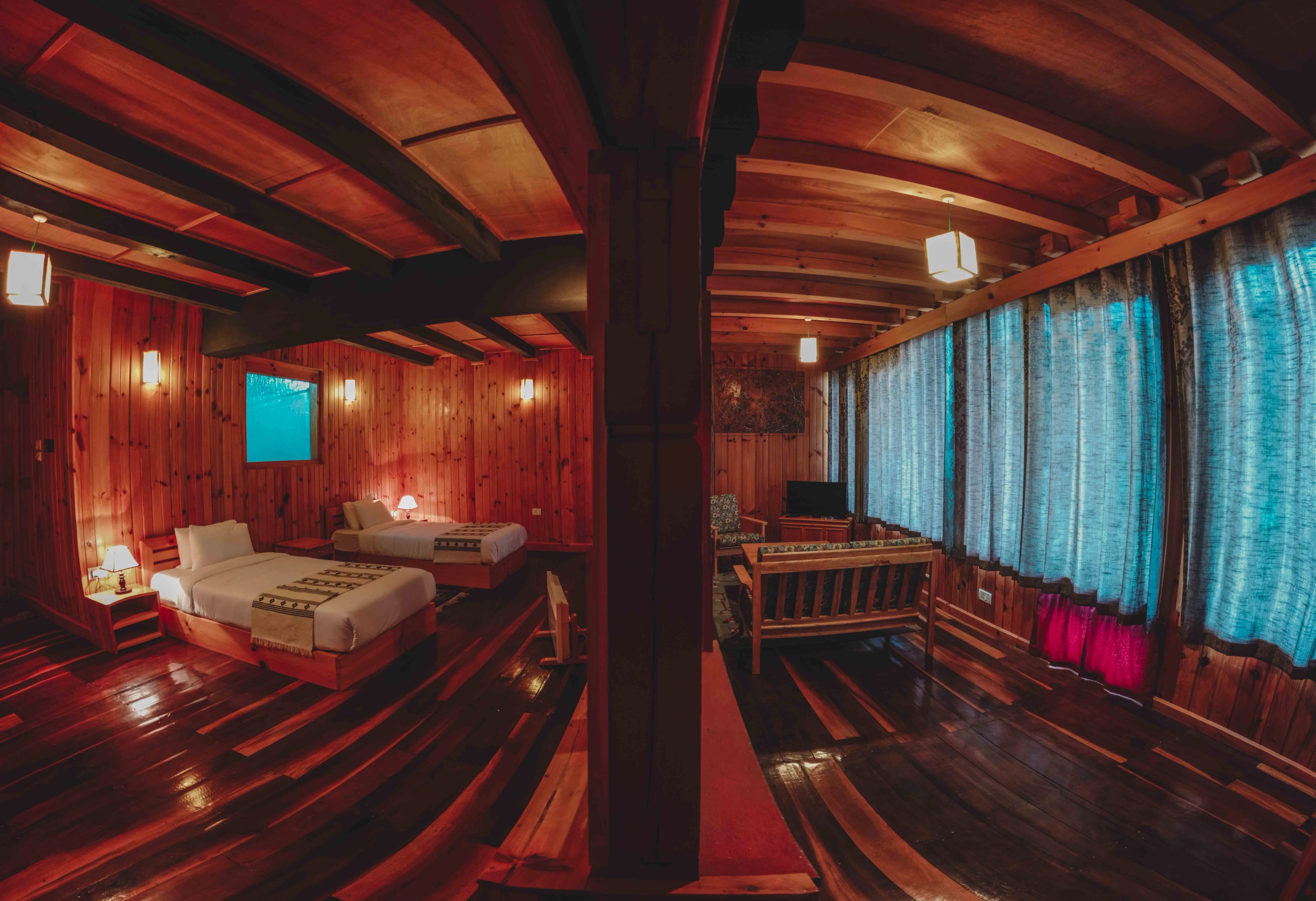 A fish eye shot of Room 203 featuring the twin beds and the sofa lounge area