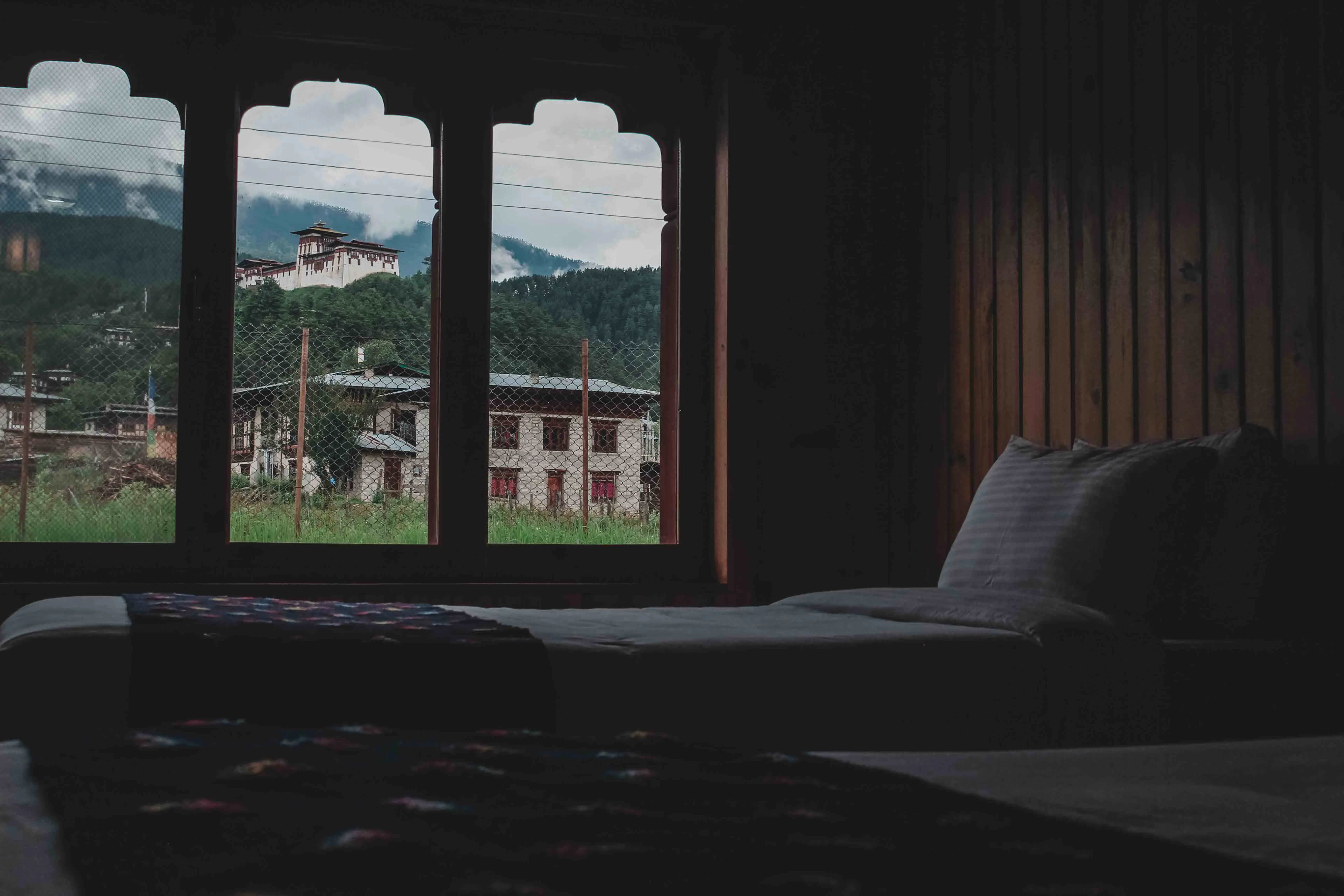 Dekyil Deluxe 205 corner view of the twin beds with Jakar Dzong in the background
