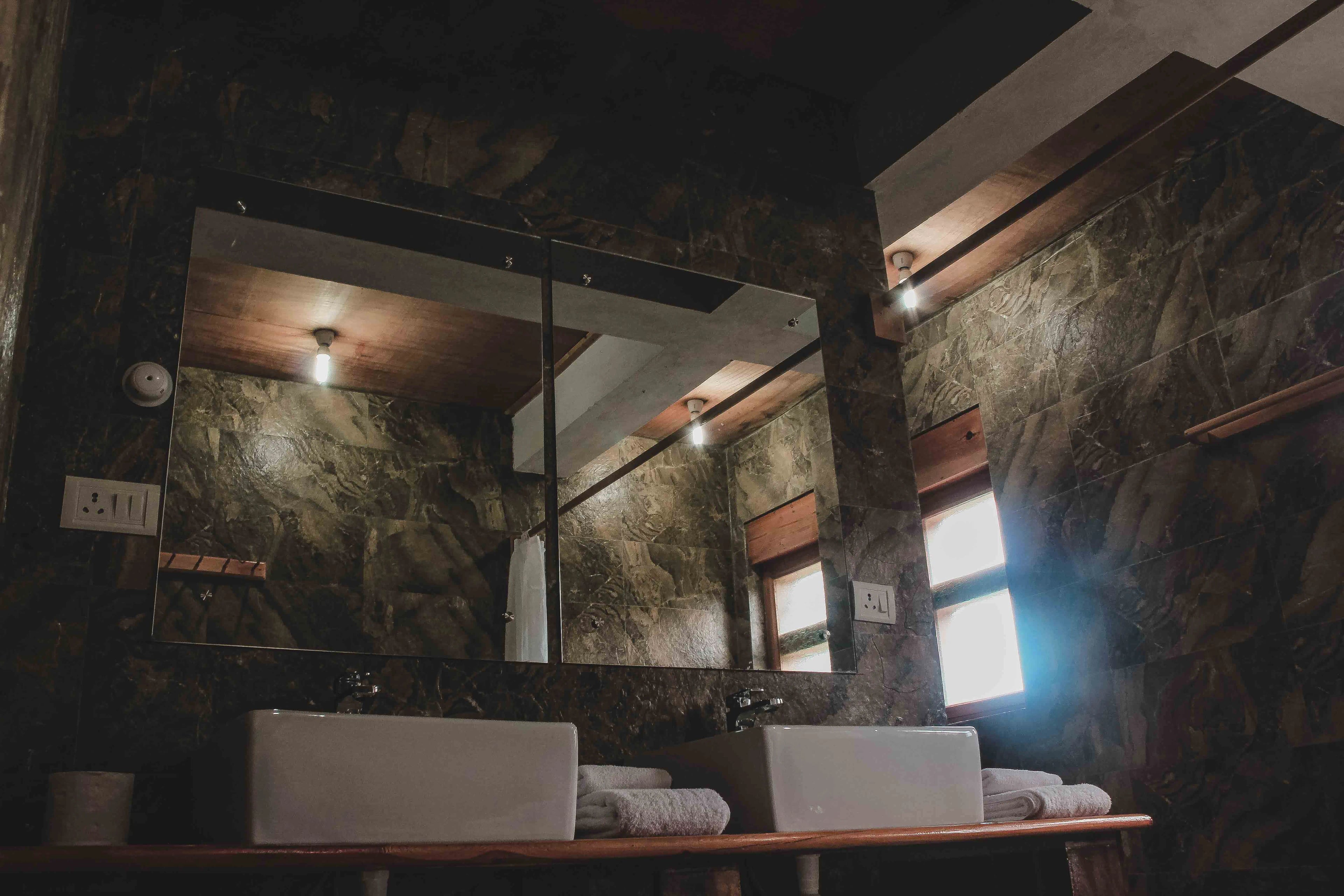 A mirror shot of the sink and the bathroom tiles